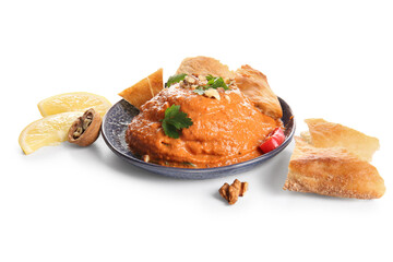 Plate of tasty muhammara with pita and ingredients on white background
