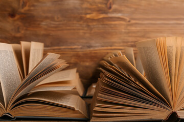 Open old books on wooden background, closeup