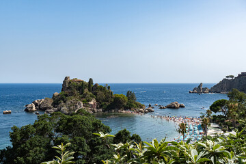 View of Isola Bella island in Taormina, Sicily, Beach with tourists surrounded by the Sea