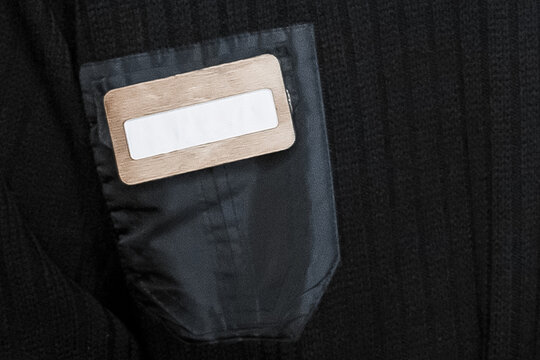Badge on dark clothes, security guard pocket empty space blank text for name design close-up