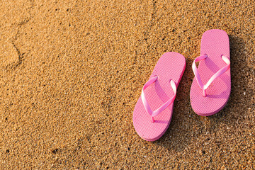 Fototapeta na wymiar Stylish flips flops on sand at resort