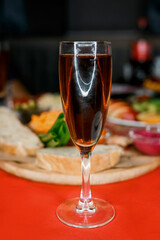 A glass of red wine stands on the festive table close-up