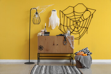 Interior of room decorated for Halloween with commode and lamp