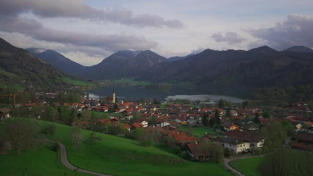 View of mountains and mountain lake in summer. Beautiful town of Schliersee in Bavaria, Germany, Europe. Lake Schliersee in bavarian mountain range. Upper Bayern. Panarama auf den Schliersee. 