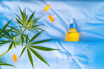 Bottle of cannabis oil, CBD, marijuana leaf, sleeping under covers