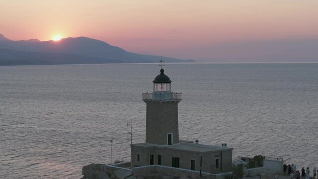 Lighthouse in Melagavi, Corinth, Greece at sunset