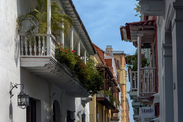 narrow street balconies with decoration of nature with flowers on the historical walled city of Cartagena de Indias Colombia
