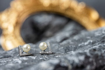 A beautiful Pearl Ear studs. Close-up of white pearl earrings.
