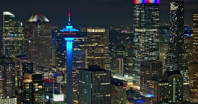 Calgary AB Canada Aerial v3 establishing night hyperlapse zoomed 3x capturing illuminated downtown cityscape with glowing and shimmering skyscrapers exteriors - Shot with Mavic 3 Pro Cine - July 2023