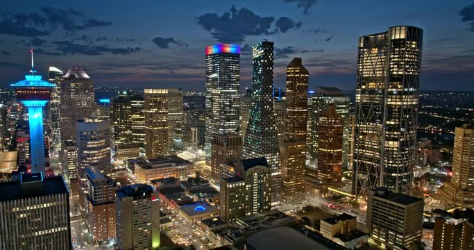 Calgary AB Canada Aerial v2 dusk to night hyperlapse capturing illuminated downtown cityscape, featuring some of the tallest skyscrapers on the city skyline - Shot with Mavic 3 Pro Cine - July 2023
