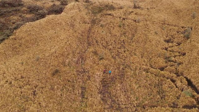 Two hikers walking on Casahuala Mountain in Ecuador, South America. Aerial