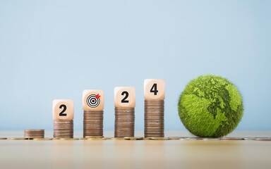The year 2024 and the mark on the pile of coins New start-up ideas for investing in green...