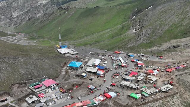 Aerial Flying Over Mountain Top Shops And Huts To Reveal Winding Road At Babusar Pass. Push Forward, Tilt Down Shot