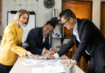 Asian businessmen, women and men Talk about new projects, presents at home office.