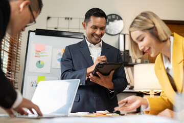 Asian businessmen, women and men Talk about new projects, presents at home office.