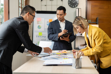 Group of Asian businessmen met, gave presentations, talked and exchanged knowledge at the office.