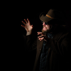 Man person cowboy portrait in hat with sunglasses. Argue hands