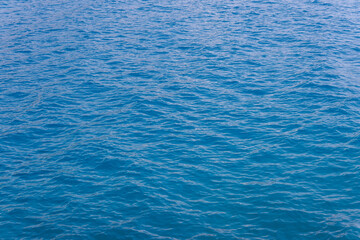 generic boundless sea water surface, only blue water at day time with mild ripple vawes.
