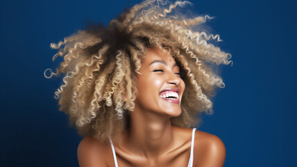 Happy young african american woman on a solid background