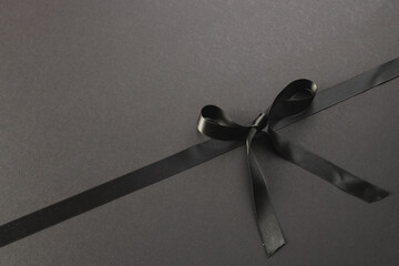 Black gift ribbon and bow with copy space on black background