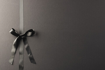 Black gift ribbon and bow with copy space on black background