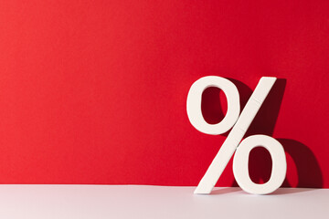 White percent sign with copy space against red background