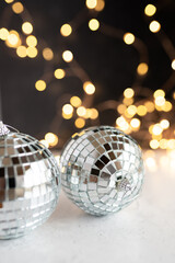 Two silver disco balls and gold party lights