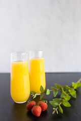 Two mimosas with strawberry garnish