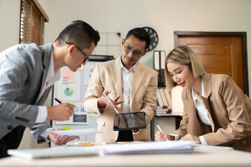 Group of Asian businessmen met, gave presentations, talked and exchanged knowledge at the office.