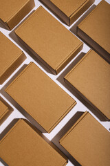 Vertical image of rows of cardboard gift boxes with copy space over white background