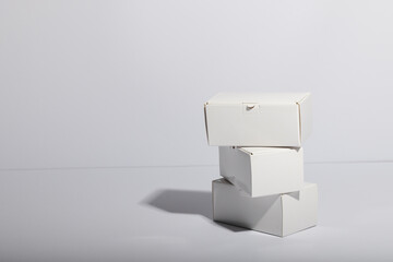 Stack of cardboard gift boxes with copy space over white background