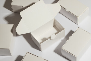 Open cardboard gift box and boxes with copy space over white background