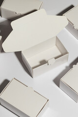 Vertical image of open cardboard gift box and boxes with copy space over white background