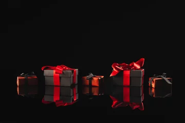 Foto op Plexiglas anti-reflex Black and red gift boxes with ribbon and copy space over black background © vectorfusionart