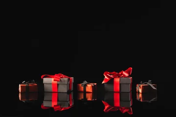 Zelfklevend Fotobehang Black and red gift boxes with ribbon and copy space over black background © vectorfusionart