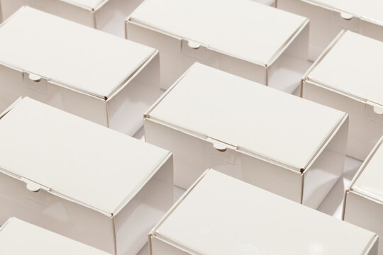 Rows of cardboard gift boxes with copy space over white background