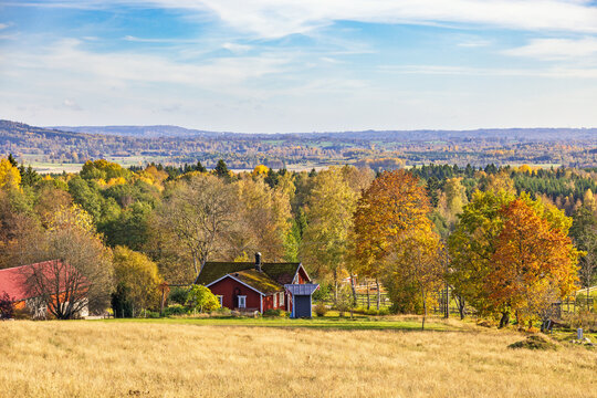 Beautiful autumn colors in the landscape with a red house