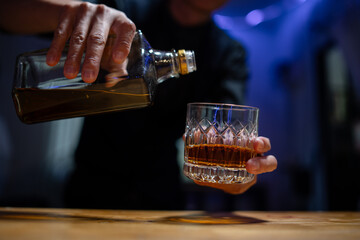 Barman pouring whiskey whiskey glass beautiful night