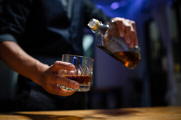 Barman pouring whiskey whiskey glass beautiful night