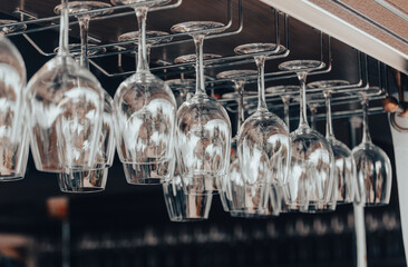 Clean glasses hang over the bar