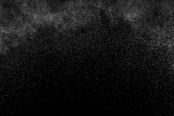 Fototapeta na wymiar Abstract splashes of water on black background. Freeze motion of white particles. Rain, snow overlay texture.