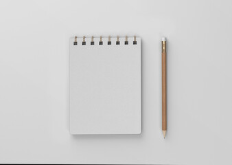 linen spiral notebook with pencil on a plain white blank empty background
