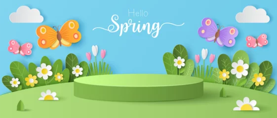 Fotobehang Paper cut of field of flowers and flocks of butterfly on blue sky background with green cylinder podium for your products display presentation. Hello spring. © jintana
