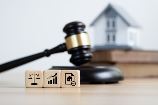 Law icon on wooden cubes. Judge auction and real estate concept. Gavel justice, hammer, and House model. Taxes and profits to invest in real estate and home buying.Concept of legal education.