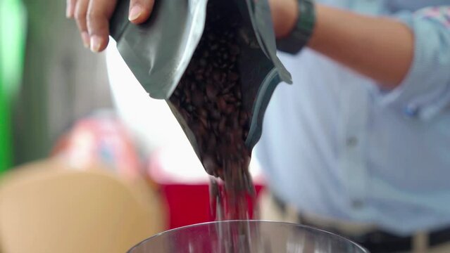 Put coffee beans into a coffee grinder