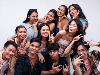 A diverse group of eleven young friends posing together looking happy. 6 women, 4 guys and 1 trans woman. Isolated on a white background.