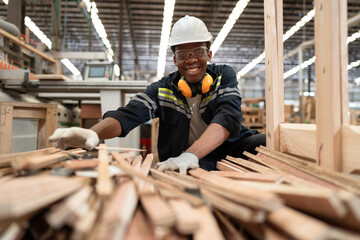 African American craft man checking timber at wood factory	