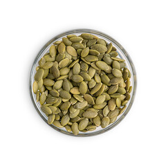 Top view of heap of dried peeled healthy pumpkin seeds also pepita of light green color served in glass bowl isolated on white background used as ingredient in culinary or as organic vegetarian snack 