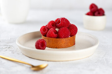 Tartlet with raspberries and cream, fresh dessert for breakfast.