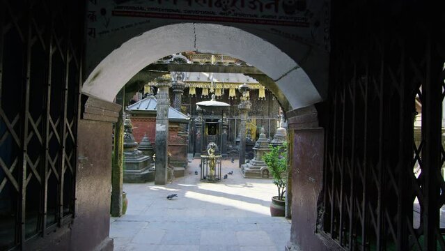 Camera flying through doorway revealing Buddhist temple. Machendra Nath temple, Jana Baha Katmandu Nepal